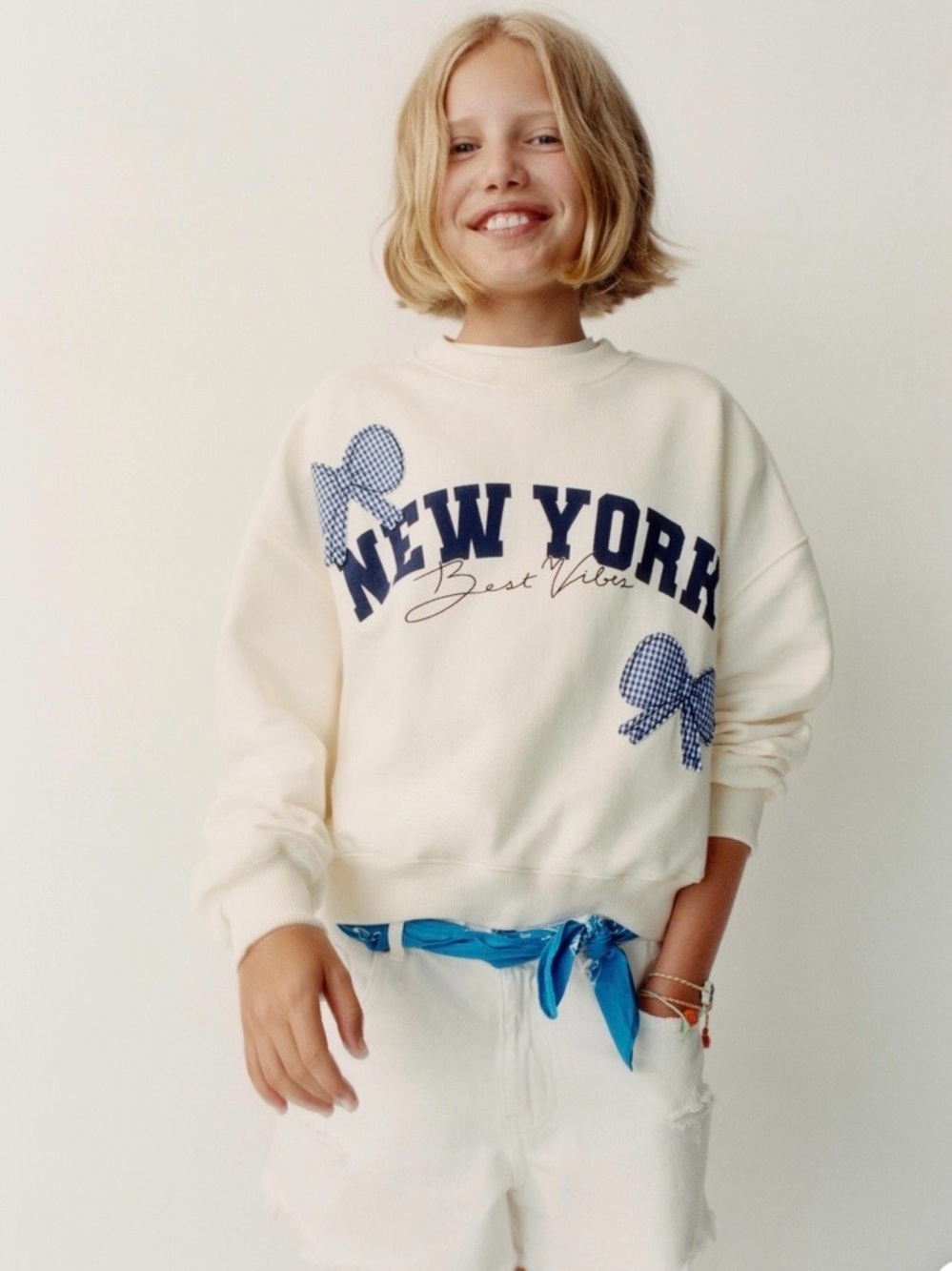 Zara Cream Sweatshirt with Navy "New York" Graphic and Blue Gingham Bows